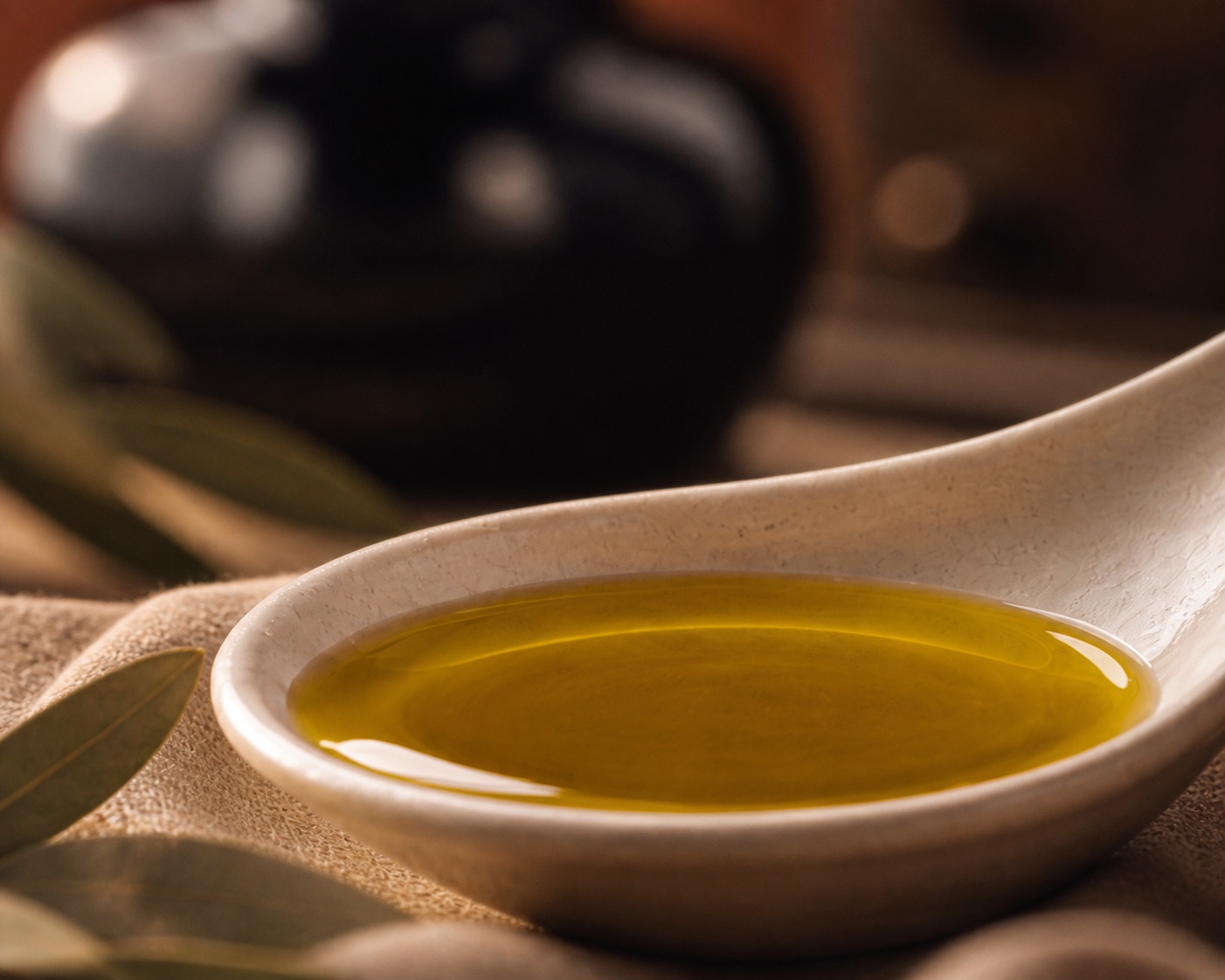 A measured spoon of green gold oil